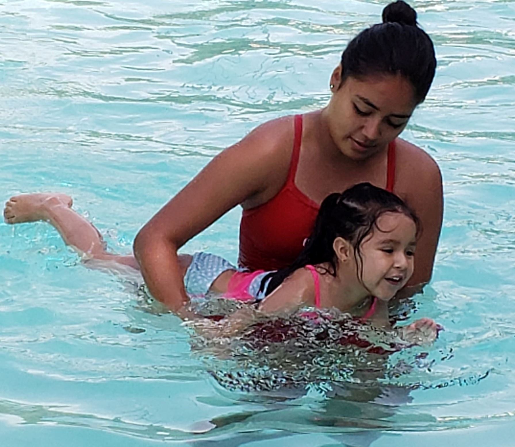 Swim lesson instructor with girl in pool